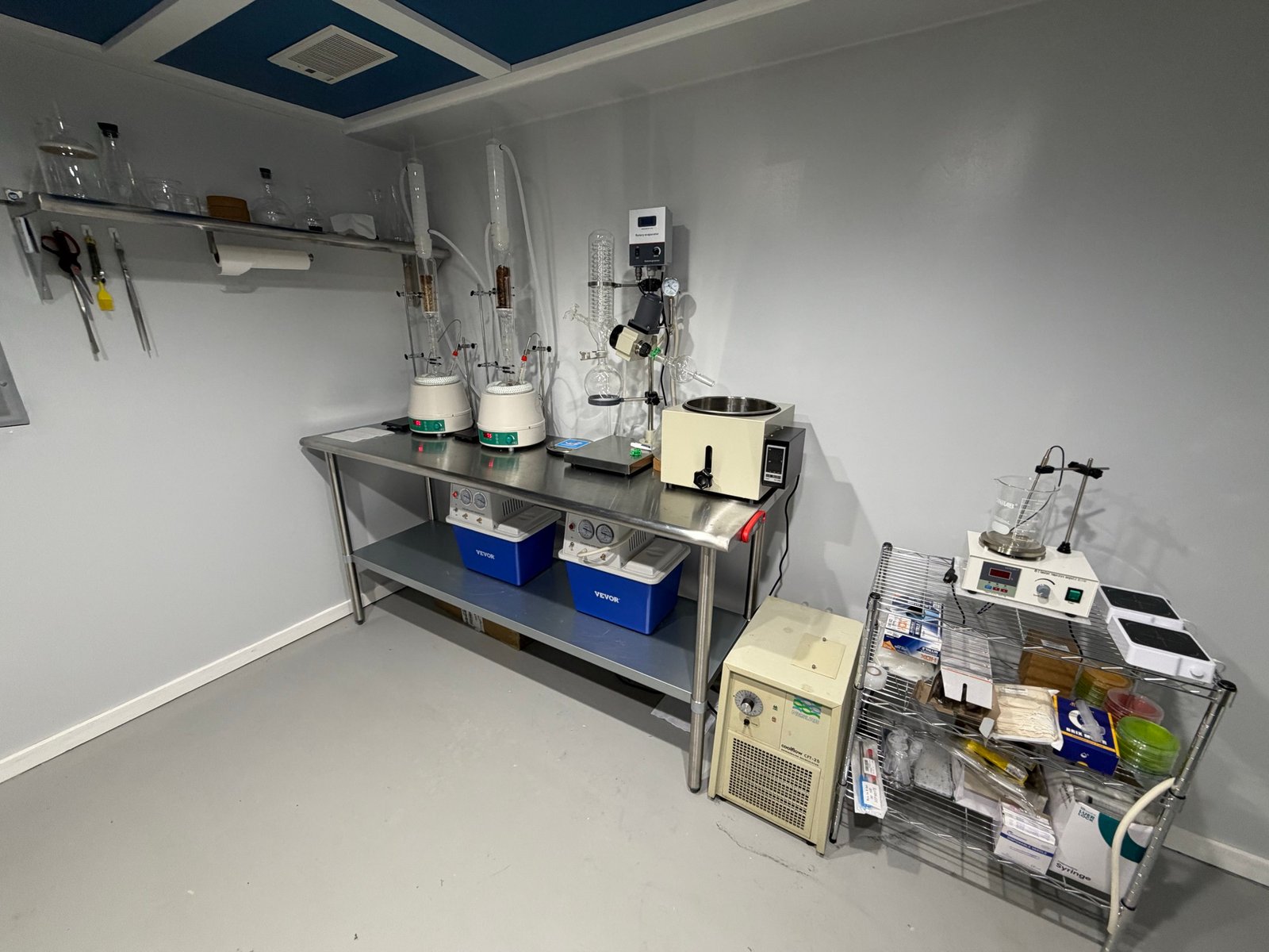 Extraction bench with soxhlets, heating mantles, and vacuum equipment for tincture work.